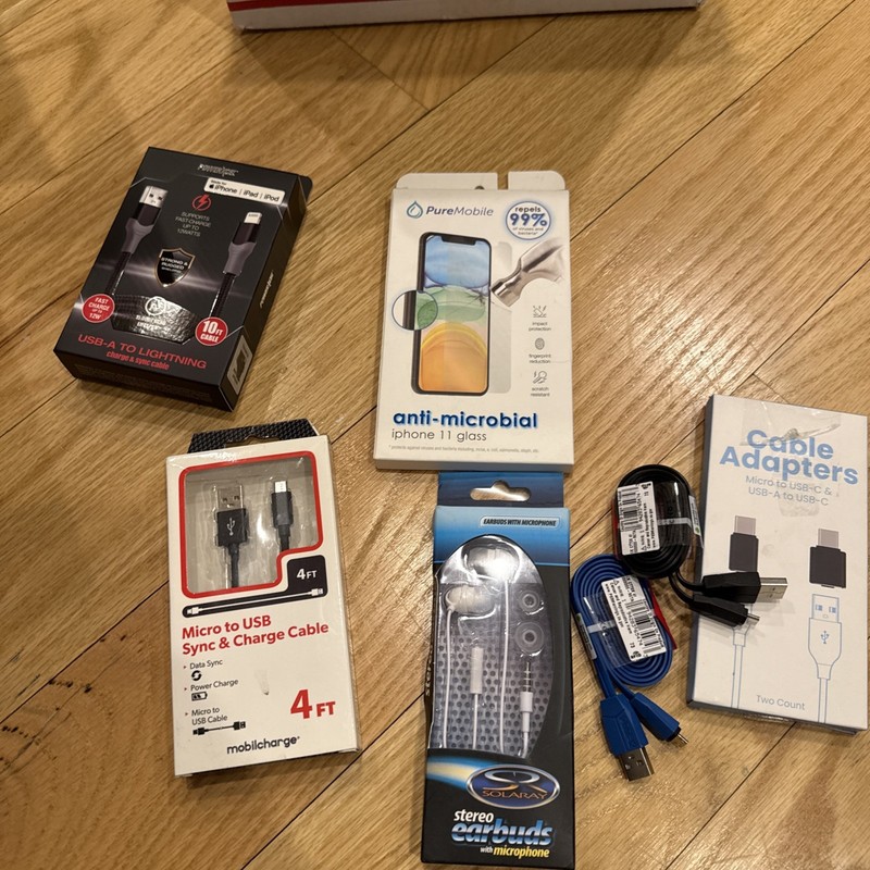 New phone accessory bundle with chargers, cables, and screen protectors